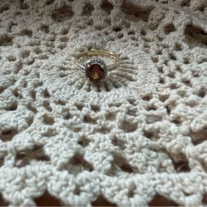 14K gold ring with a red center stone.